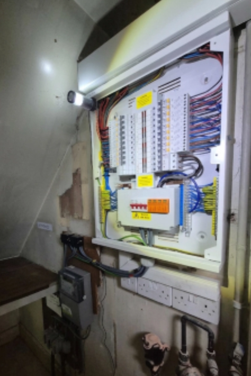 Open commercial electrical distribution board with circuit breakers and organised wiring.